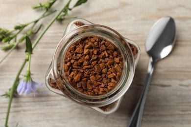 Photo of Jar of chicory granules on white wooden table, top view