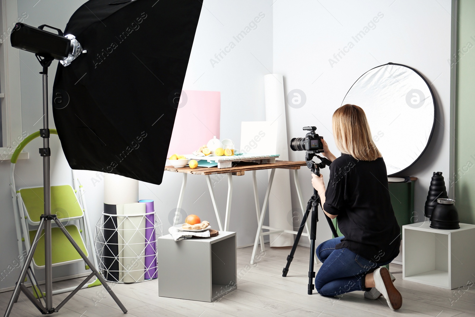 Woman taking photo of food with professional camera in studio Photo of Woman taking photo of food with professional camera in studio