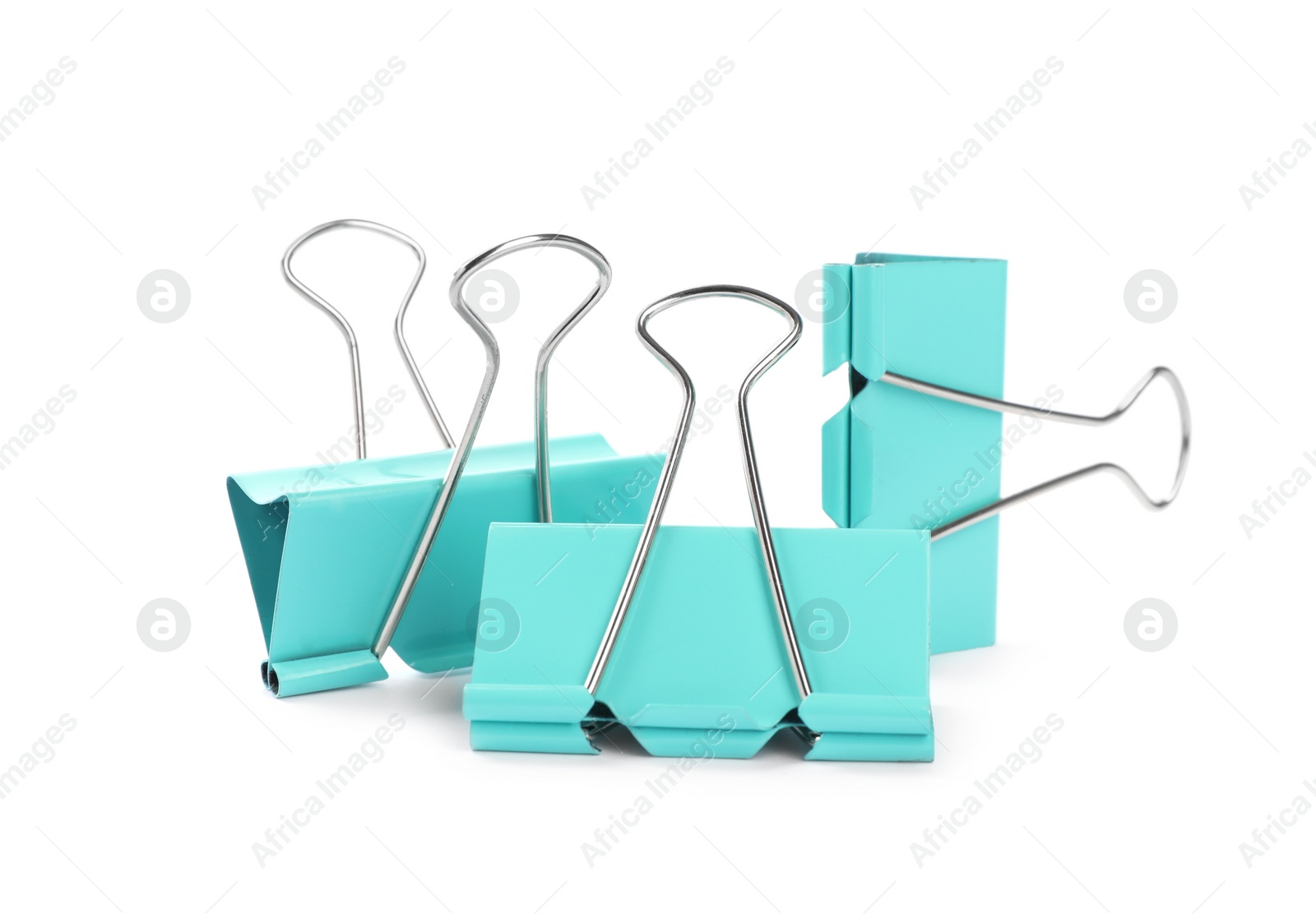 Turquoise binder clips on white background. Stationery Photo of Turquoise binder clips on white background. Stationery