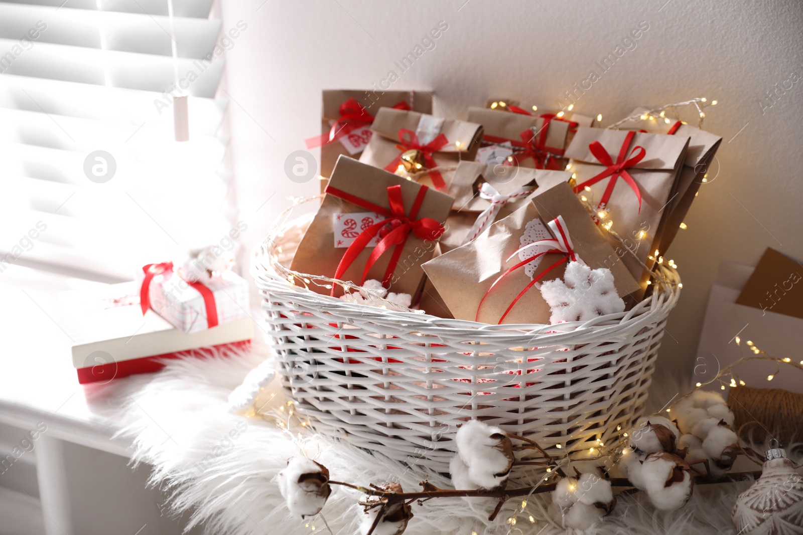 Set of gifts in basket and Christmas decor on window sill indoors. Advent calendar Photo of Set of gifts in basket and Christmas decor on window sill indoors. Advent calendar