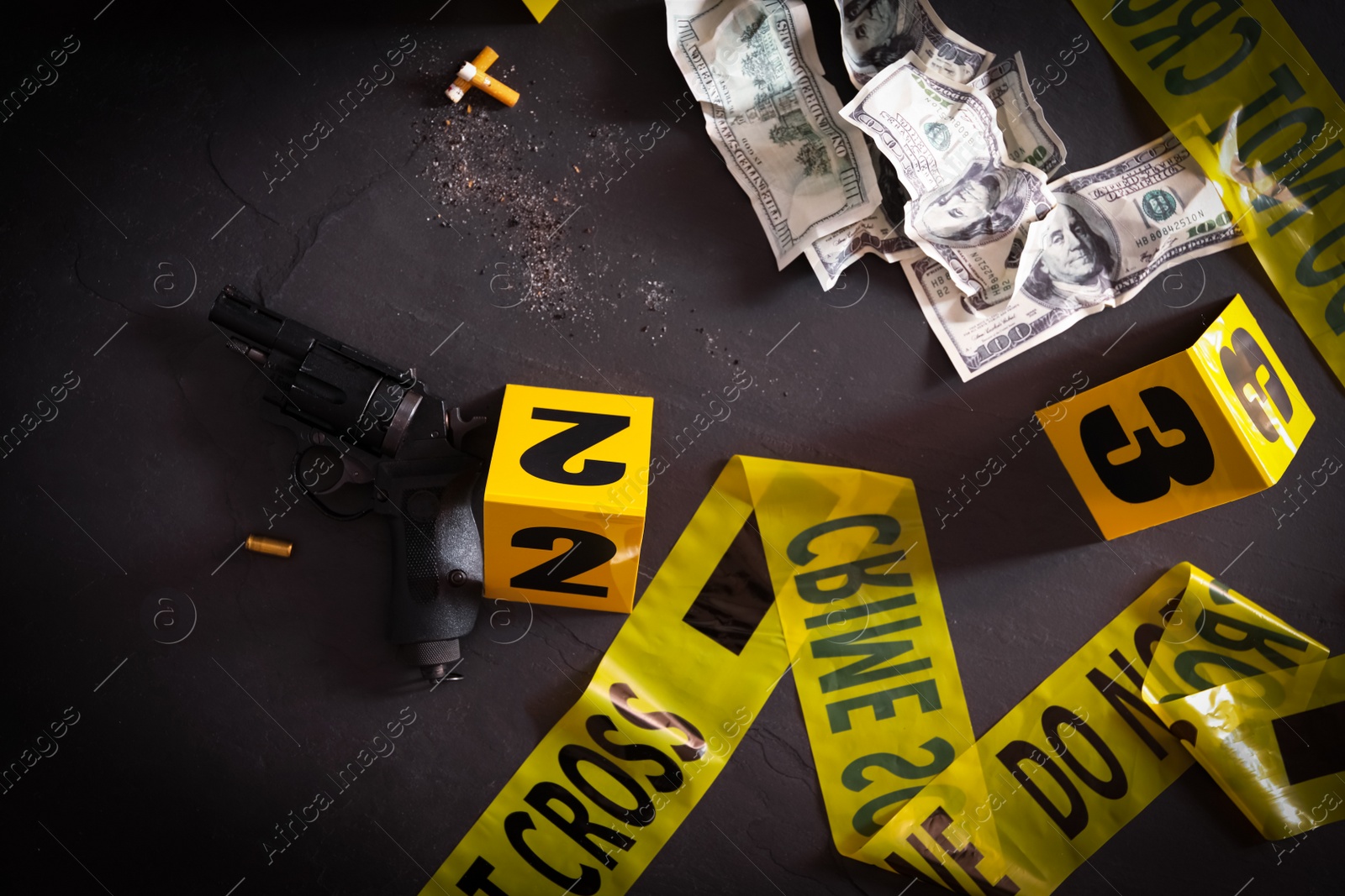 Flat lay composition with evidences and crime scene markers on black background Photo of Flat lay composition with evidences and crime scene markers on black background