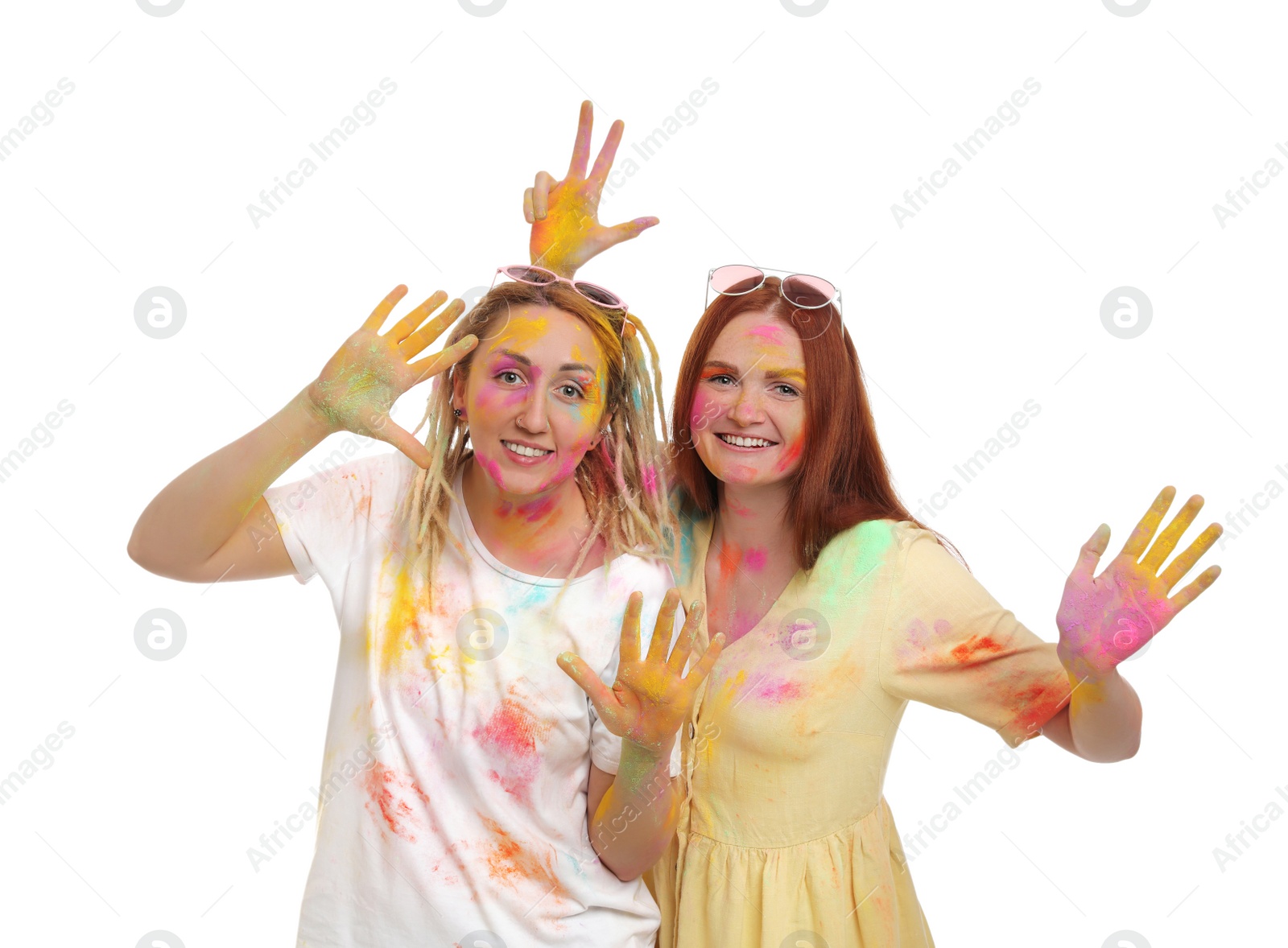 Women covered with colorful powder dyes on white background. Holi festival celebration Photo of Women covered with colorful powder dyes on white background. Holi festival celebration