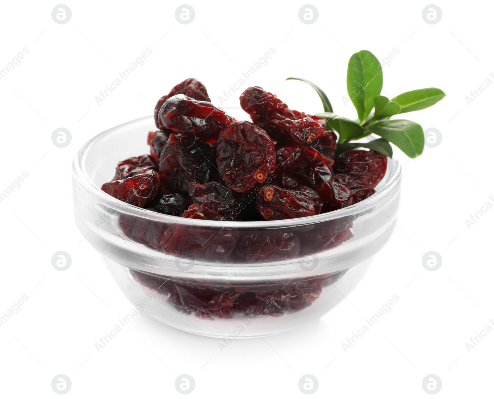 Tasty dried cranberries and leaves in bowl isolated on white Photo of Tasty dried cranberries and leaves in bowl isolated on white
