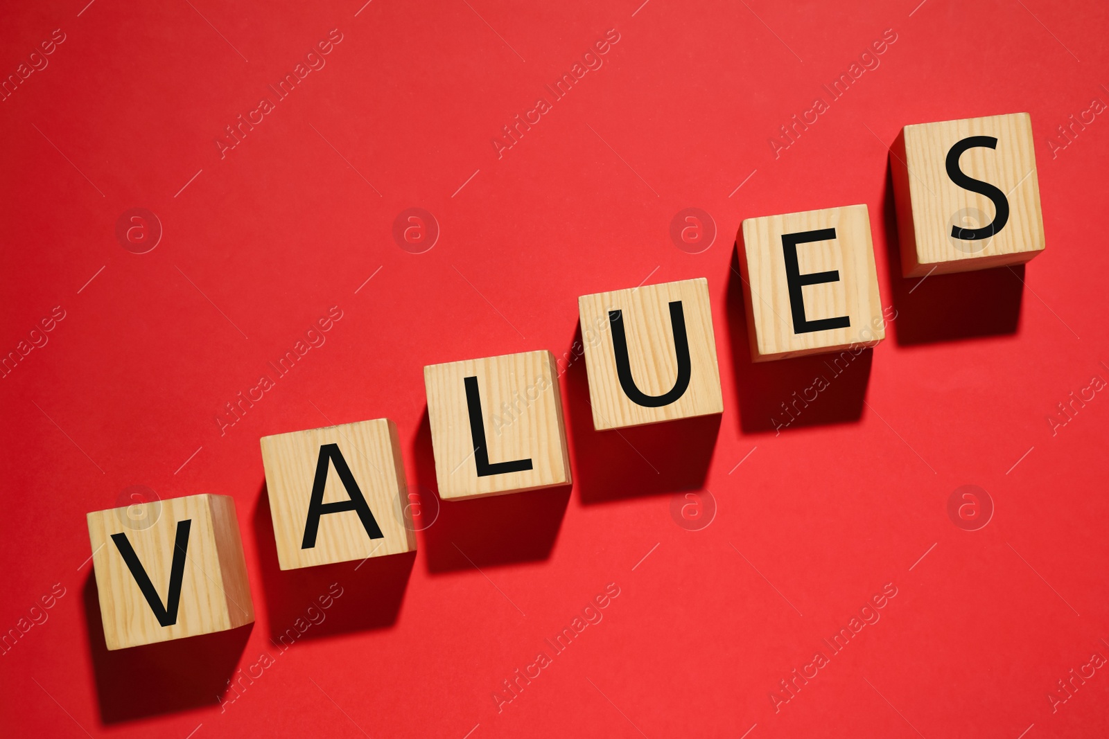 Wooden cubes with word VALUES on red background, flat lay Photo of Wooden cubes with word VALUES on red background, flat lay