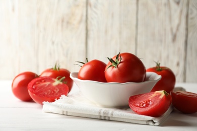 Fresh ripe tomatoes on white wooden table Photo of Fresh ripe tomatoes on white wooden table