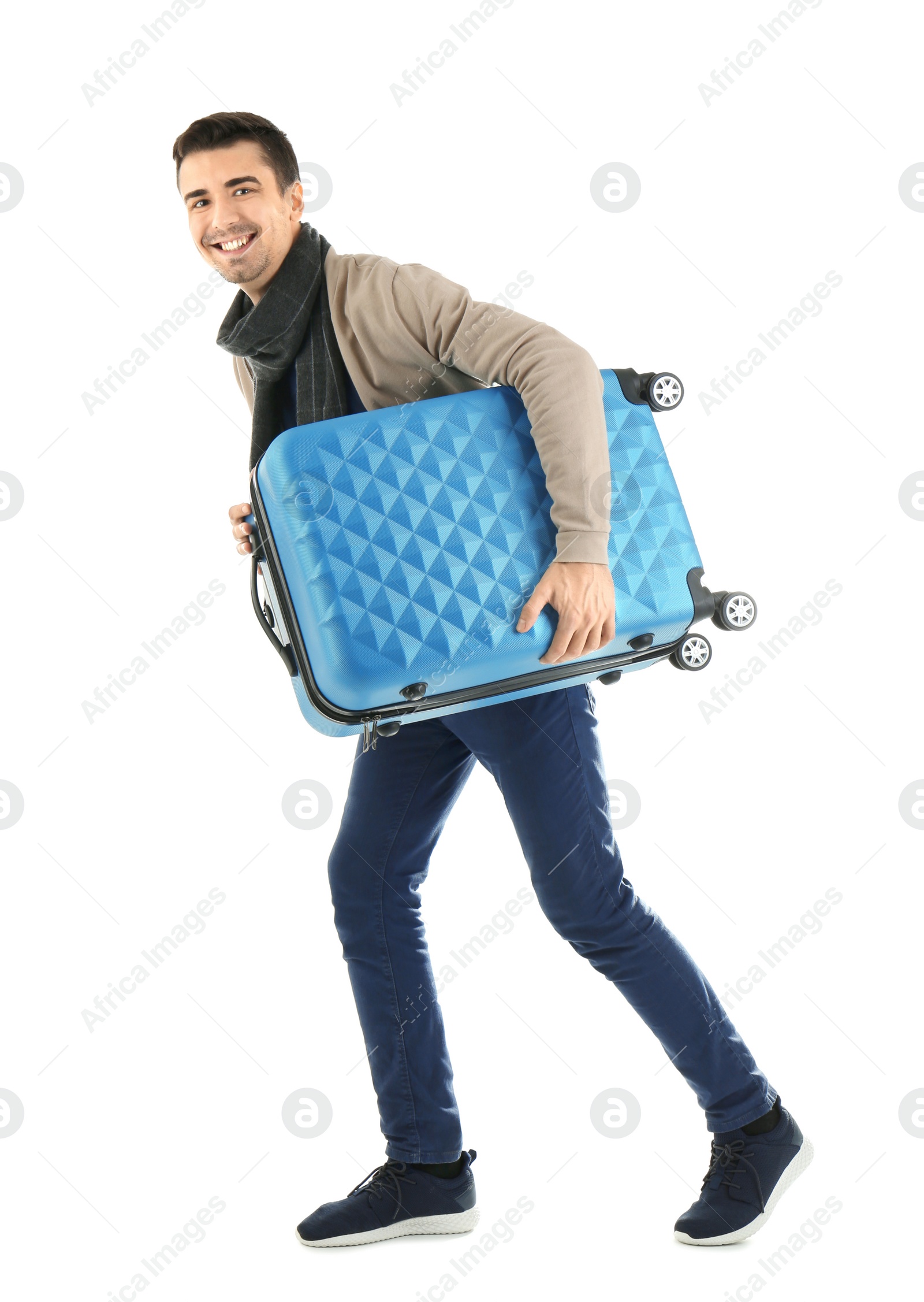 Young man with suitcase on white background. Ready for winter vacation Photo of Young man with suitcase on white background. Ready for winter vacation