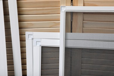 Set of window screens near wooden folding screen, closeup Photo of Set of window screens near wooden folding screen, closeup