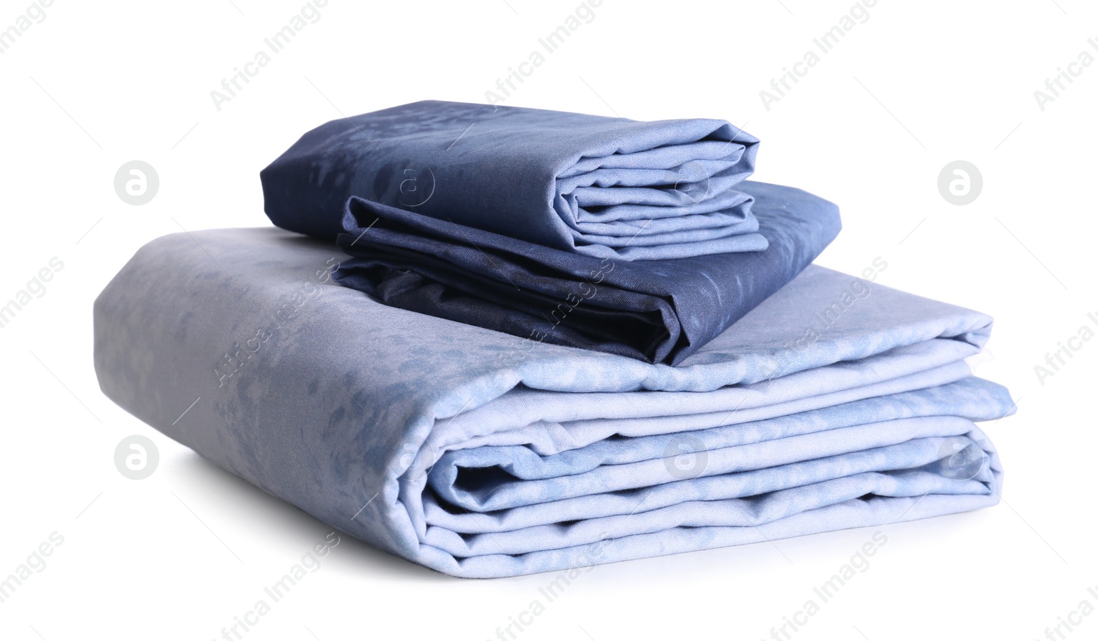 Stack of clean bed linen isolated on white Photo of Stack of clean bed linen isolated on white