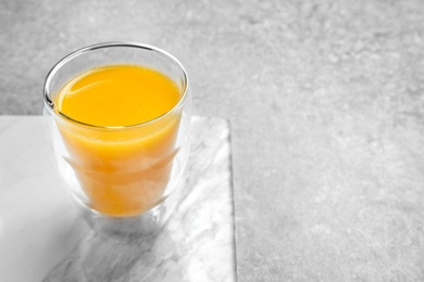 Glass of orange juice on table Photo of Glass of orange juice on table