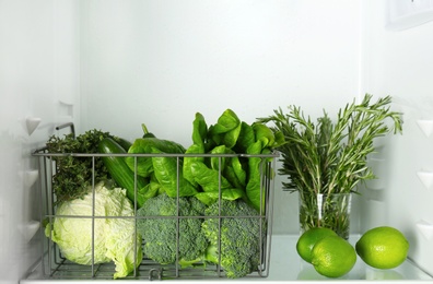 Photo of Different green vegetables and fruit in refrigerator