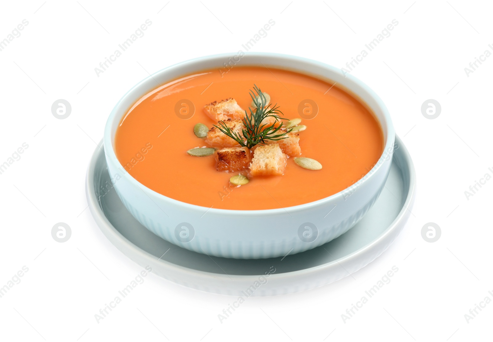 Tasty creamy pumpkin soup with croutons, seeds and dill in bowl on white background Photo of Tasty creamy pumpkin soup with croutons, seeds and dill in bowl on white background