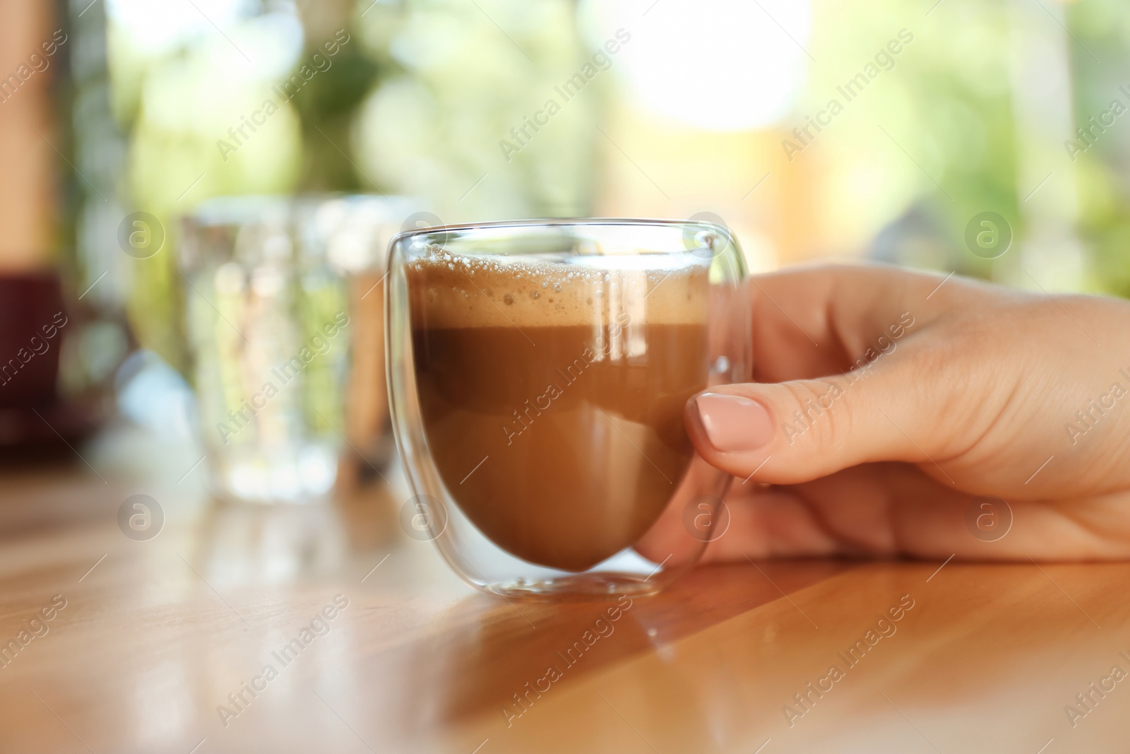 Woman with aromatic coffee at table in cafe, closeup Photo of Woman with aromatic coffee at table in cafe, closeup