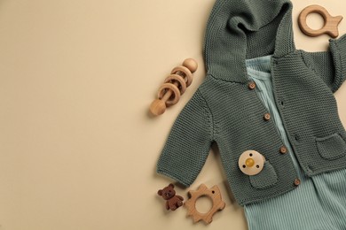 Flat lay composition with baby clothes and accessories beige background, space for text Photo of Flat lay composition with baby clothes and accessories beige background, space for text
