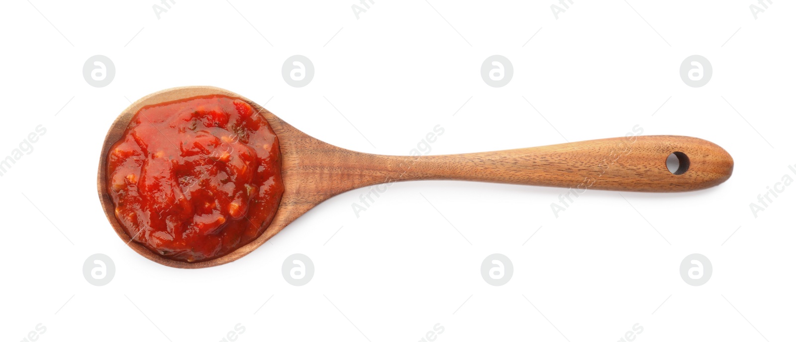 Delicious adjika sauce in wooden spoon isolated on white, top view Photo of Delicious adjika sauce in wooden spoon isolated on white, top view