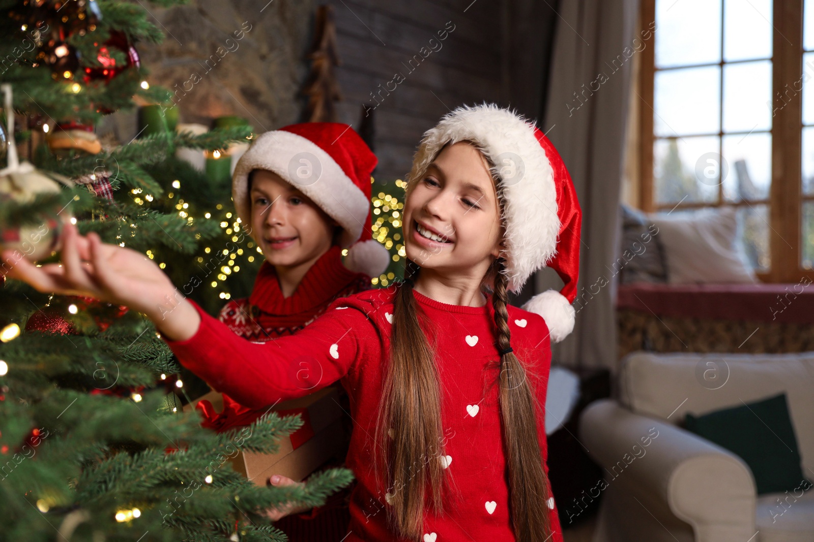 Happy children near beautiful Christmas tree at home Photo of Happy children near beautiful Christmas tree at home