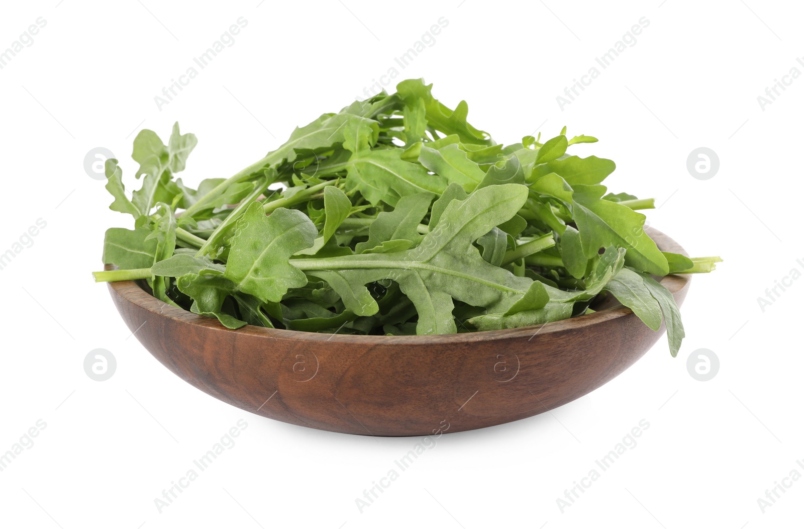 Delicious fresh arugula in wooden bowl isolated on white Photo of Delicious fresh arugula in wooden bowl isolated on white
