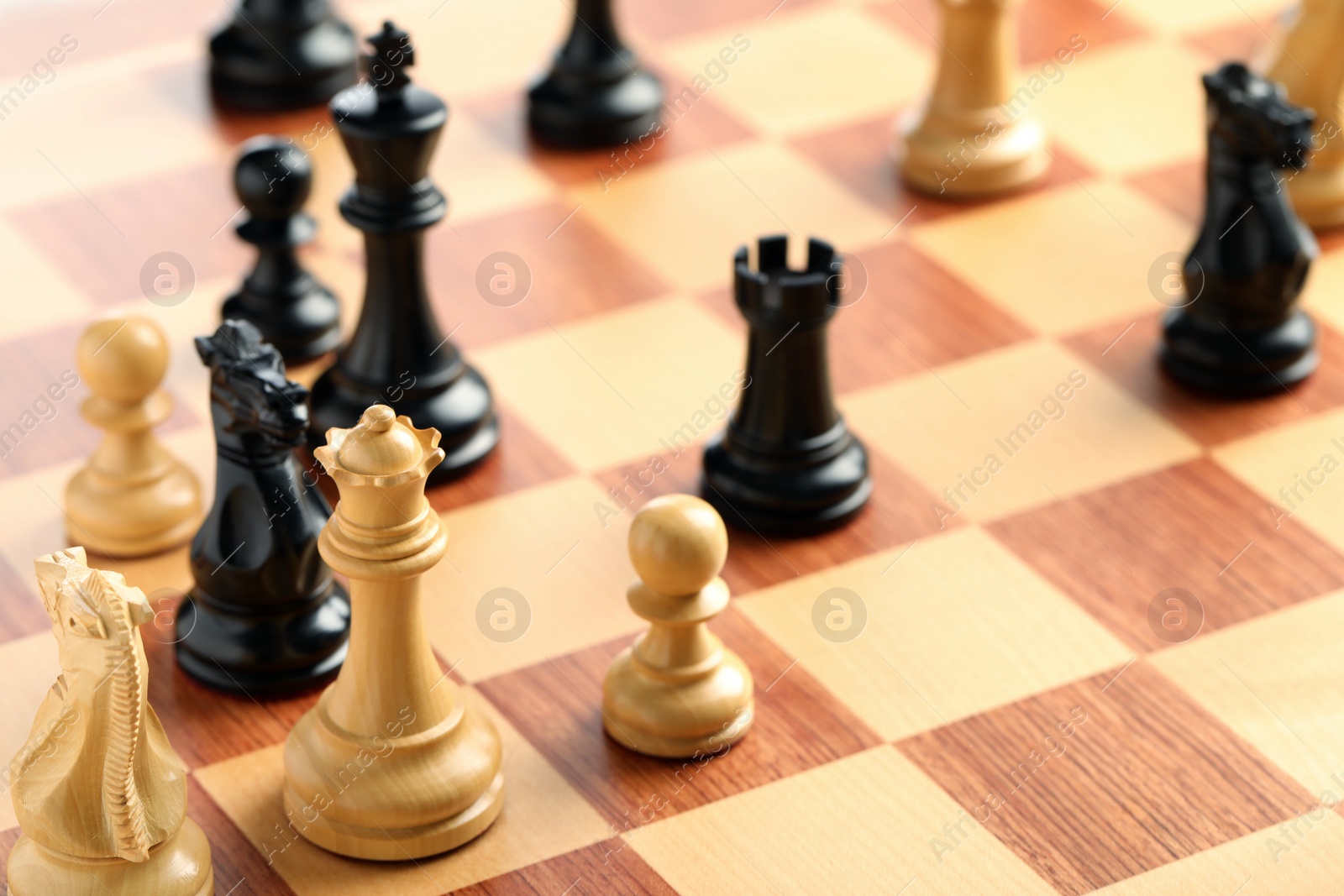 Photo of Wooden chessboard with game pieces as background