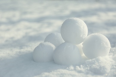 Perfect round snowballs on snow outdoors, closeup Photo of Perfect round snowballs on snow outdoors, closeup