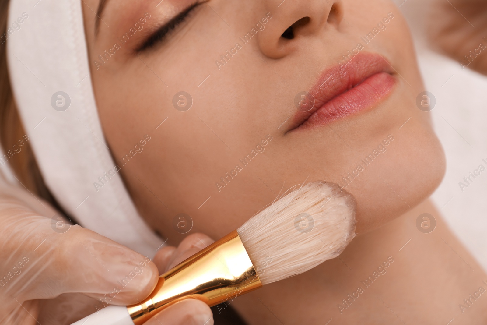 Young woman during face peeling procedure in salon, closeup Photo of Young woman during face peeling procedure in salon, closeup