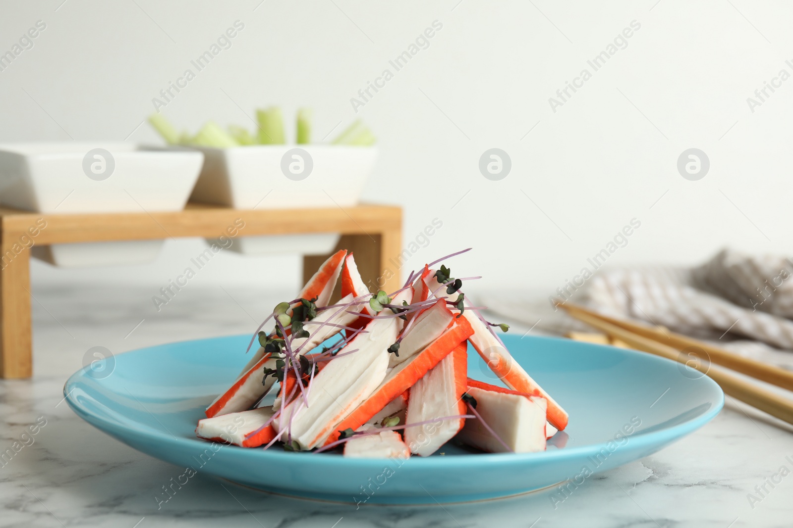Fresh cut crab sticks served on marble table Photo of Fresh cut crab sticks served on marble table