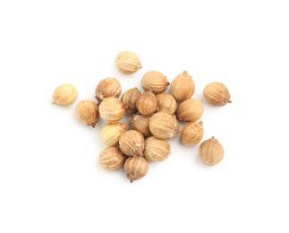 Photo of Scattered dried coriander seeds on white background, top view