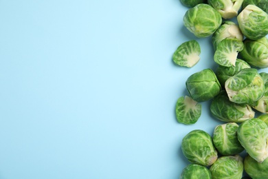 Fresh Brussels sprouts on light blue background, flat lay. Space for text Photo of Fresh Brussels sprouts on light blue background, flat lay. Space for text