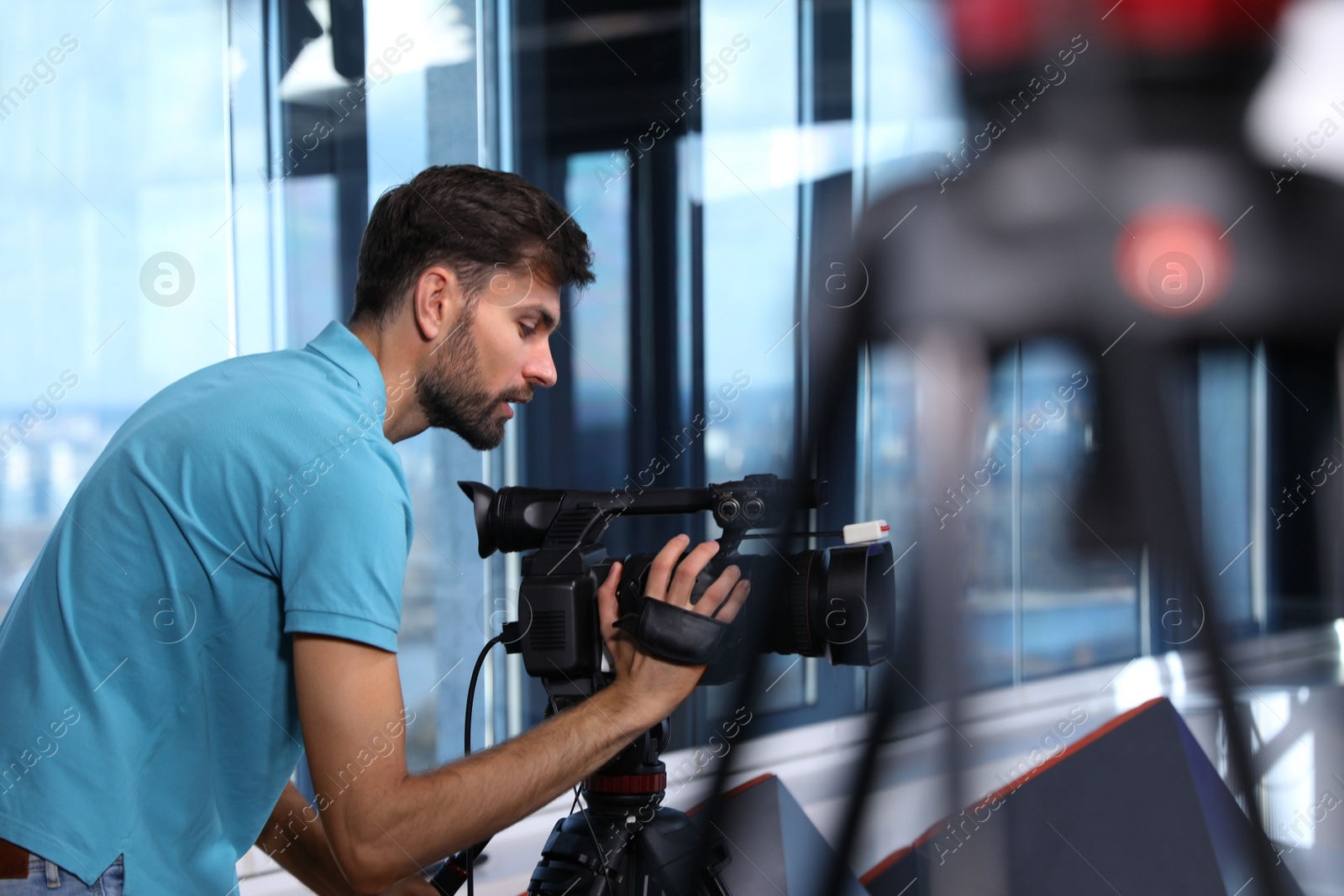 Professional video camera operator working in studio Photo of Professional video camera operator working in studio