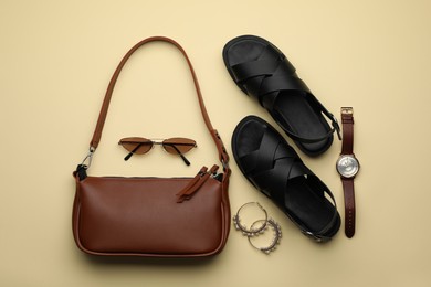 Stylish woman's bag, shoes and accessories on beige background, flat lay Photo of Stylish woman's bag, shoes and accessories on beige background, flat lay