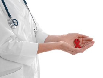 Doctor holding red awareness ribbon on white background, closeup. World AIDS disease day Photo of Doctor holding red awareness ribbon on white background, closeup. World AIDS disease day