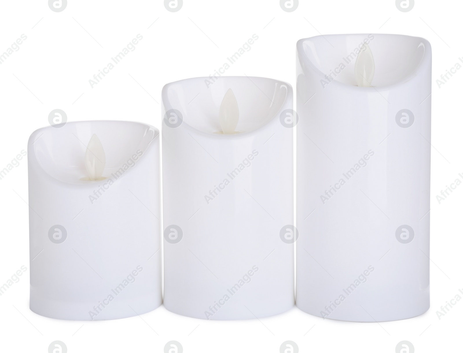 Decorative flameless LED candles on white background Photo of Decorative flameless LED candles on white background