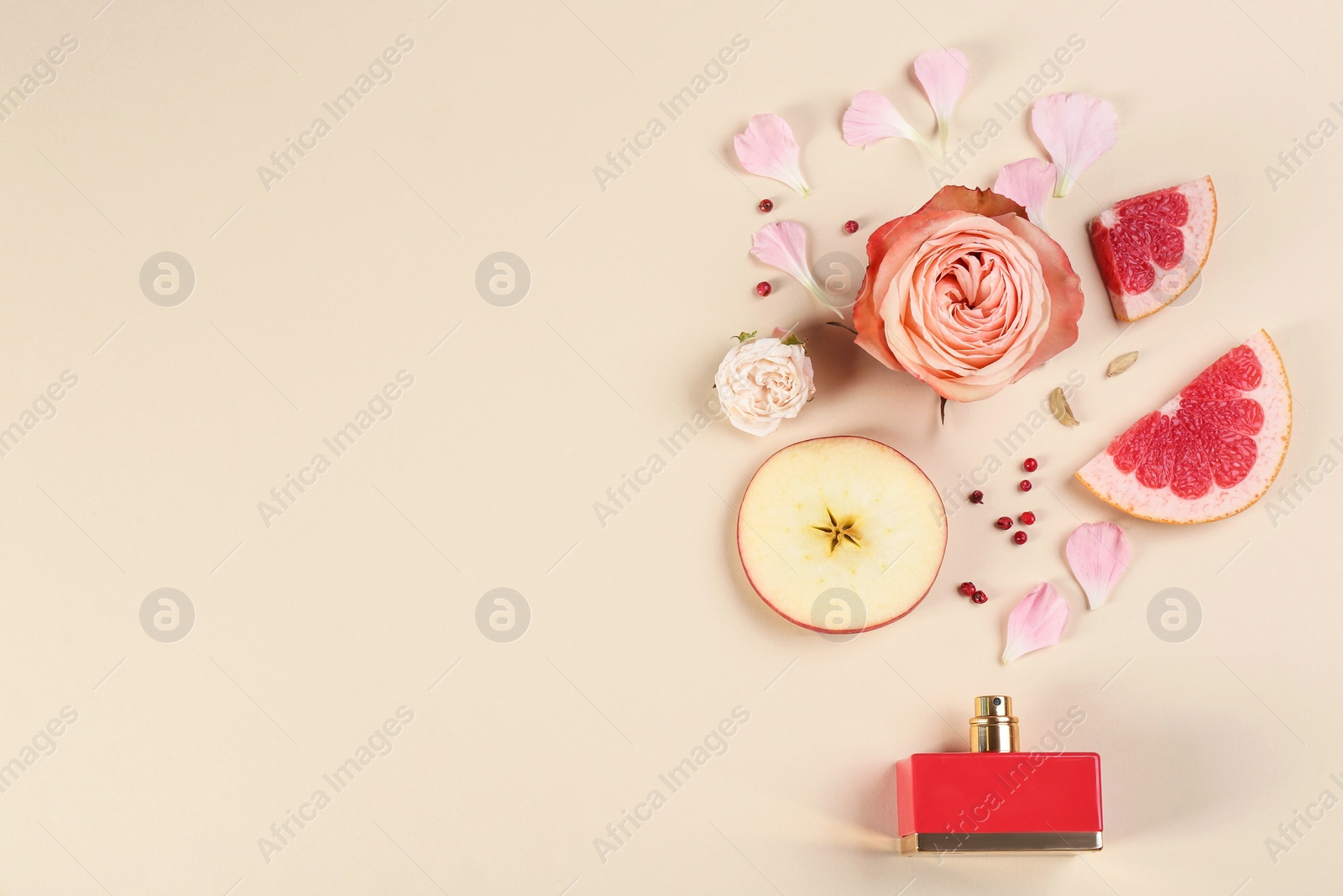 Flat lay composition with bottle of perfume on beige background, space for text Photo of Flat lay composition with bottle of perfume on beige background, space for text