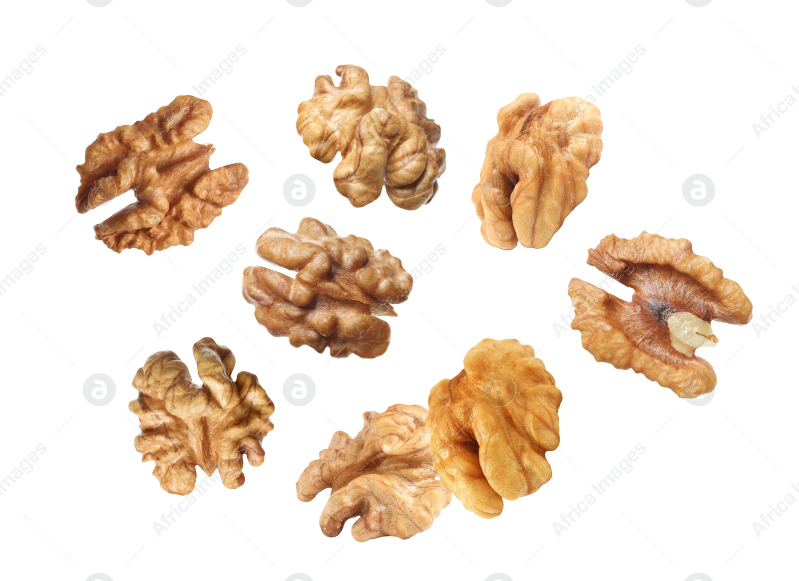 Halves of walnuts falling on white background Image of Halves of walnuts falling on white background