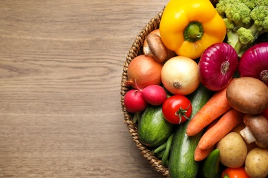 Different fresh vegetables on wooden table, top view. Space for text Photo of Different fresh vegetables on wooden table, top view. Space for text