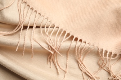 Beige soft cashmere scarf as background, closeup Photo of Beige soft cashmere scarf as background, closeup