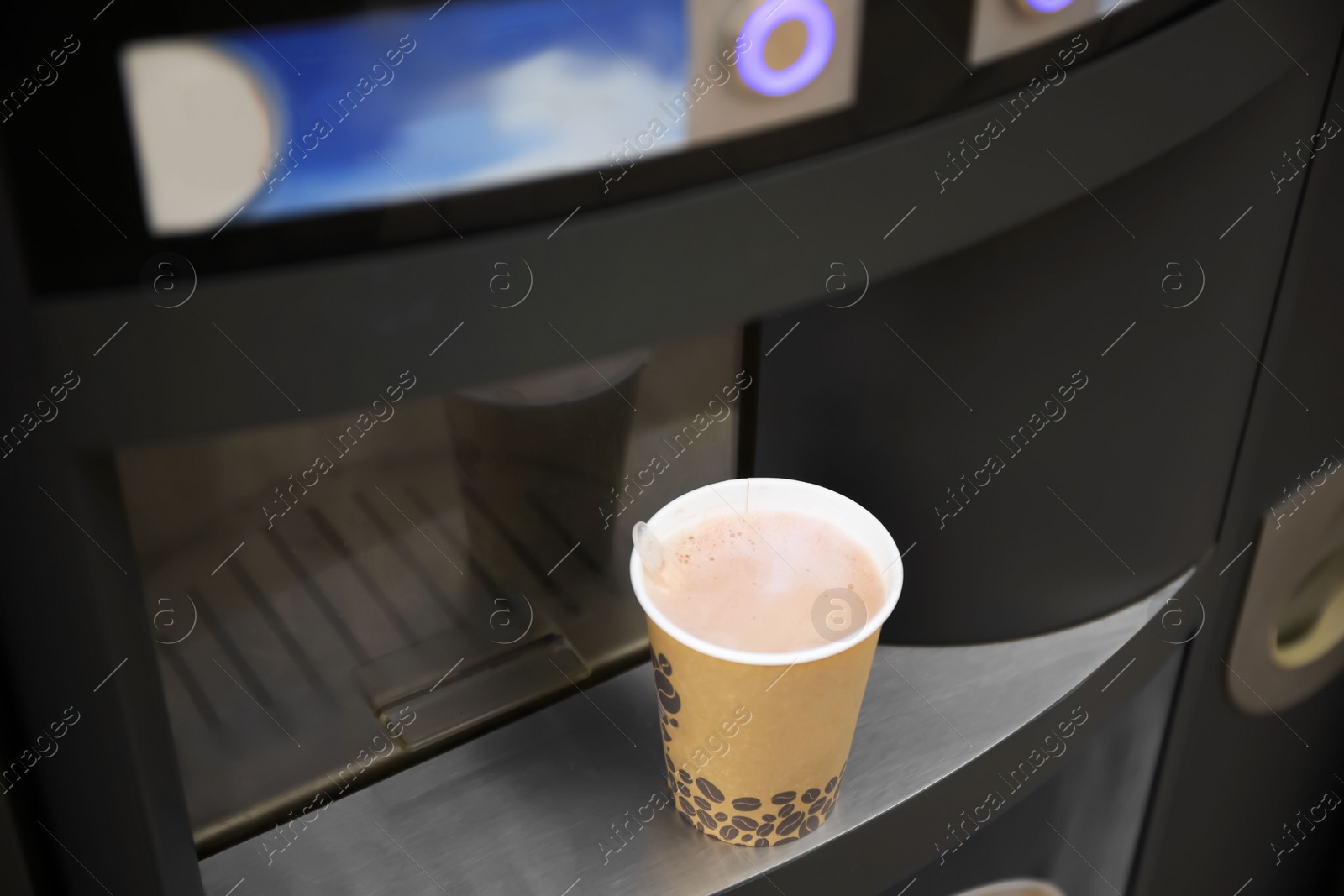Coffee and hot beverage vending machine with paper cup on drip tray, above view Photo of Coffee and hot beverage vending machine with paper cup on drip tray, above view