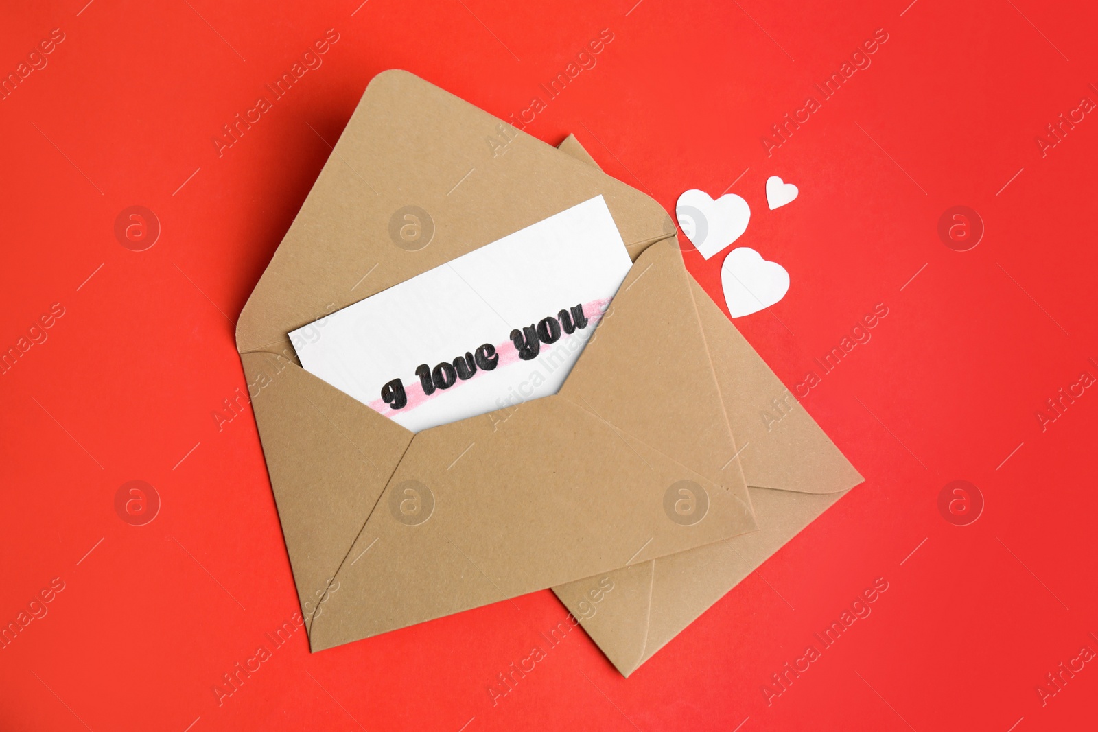 Card with phrase I Love You in envelope and paper hearts on red background, flat lay Photo of Card with phrase I Love You in envelope and paper hearts on red background, flat lay