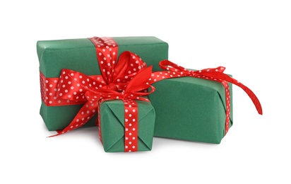 Christmas gift boxes decorated with red bows on white background Photo of Christmas gift boxes decorated with red bows on white background