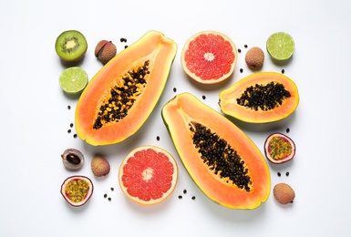 Fresh ripe papaya and other fruits on white background, top view Photo of Fresh ripe papaya and other fruits on white background, top view