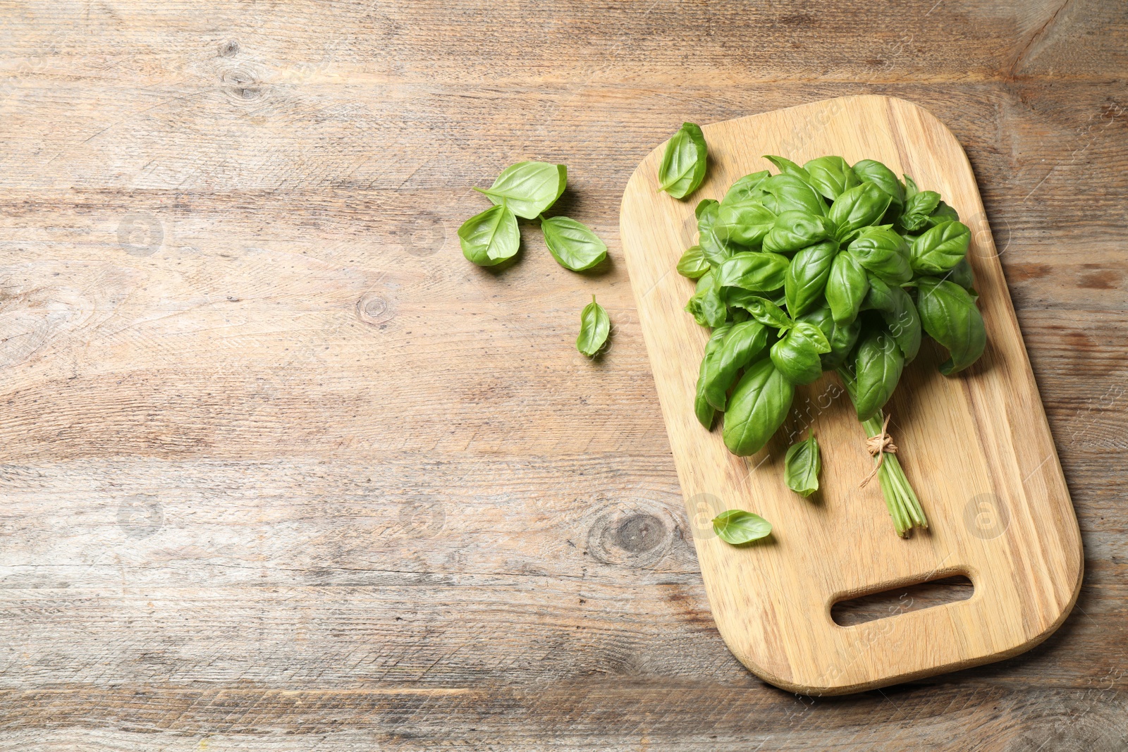 Fresh basil on wooden table, flat lay. Space for text Photo of Fresh basil on wooden table, flat lay. Space for text