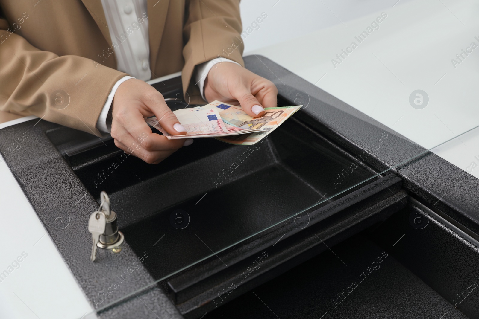 Cashier with money at bank, closeup. Currency exchange Photo of Cashier with money at bank, closeup. Currency exchange