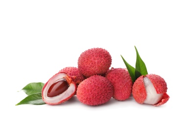 Pile of fresh ripe lychees with green leaves on white background Photo of Pile of fresh ripe lychees with green leaves on white background