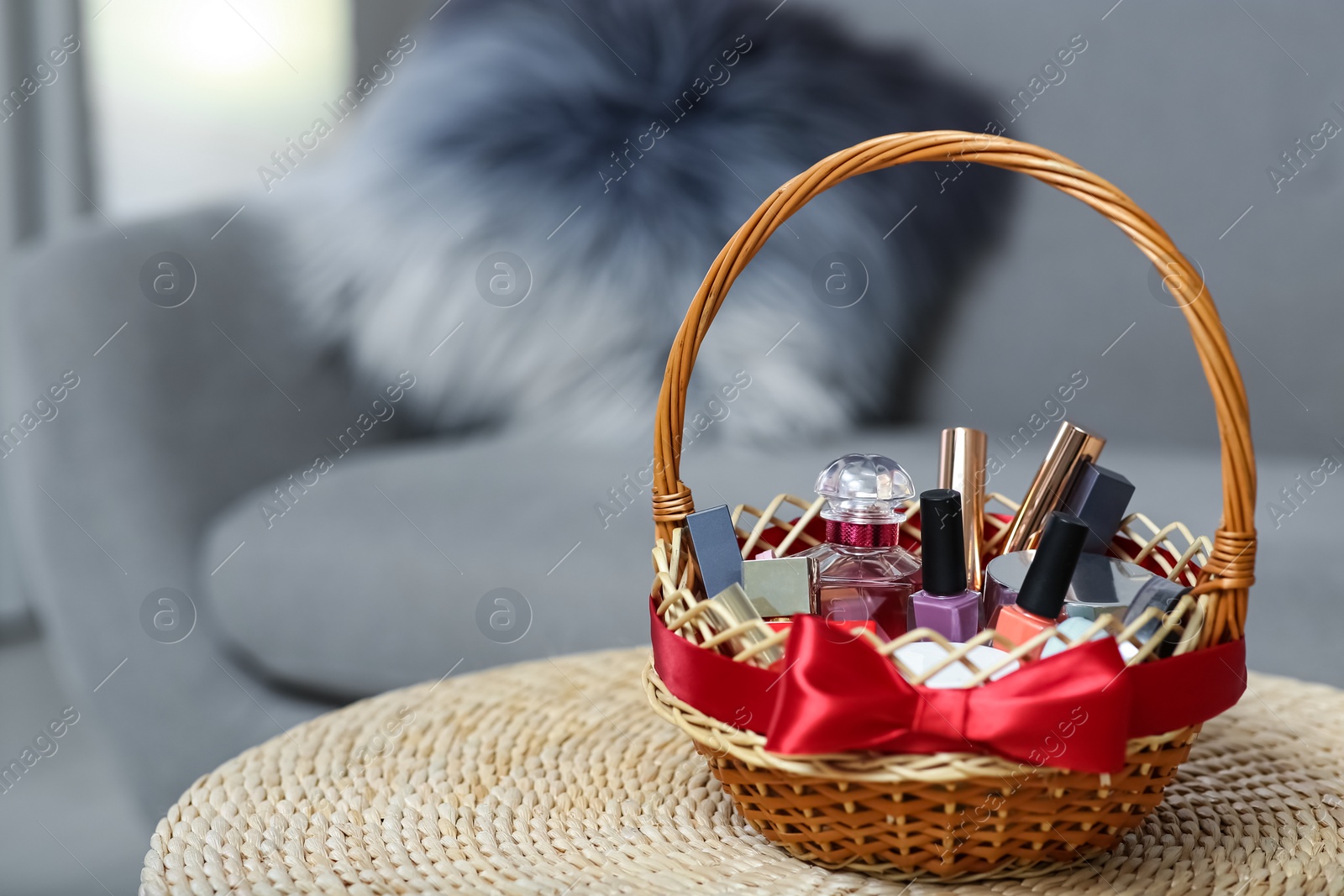 Wicker basket full of gifts in living room. Space for text Photo of Wicker basket full of gifts in living room. Space for text