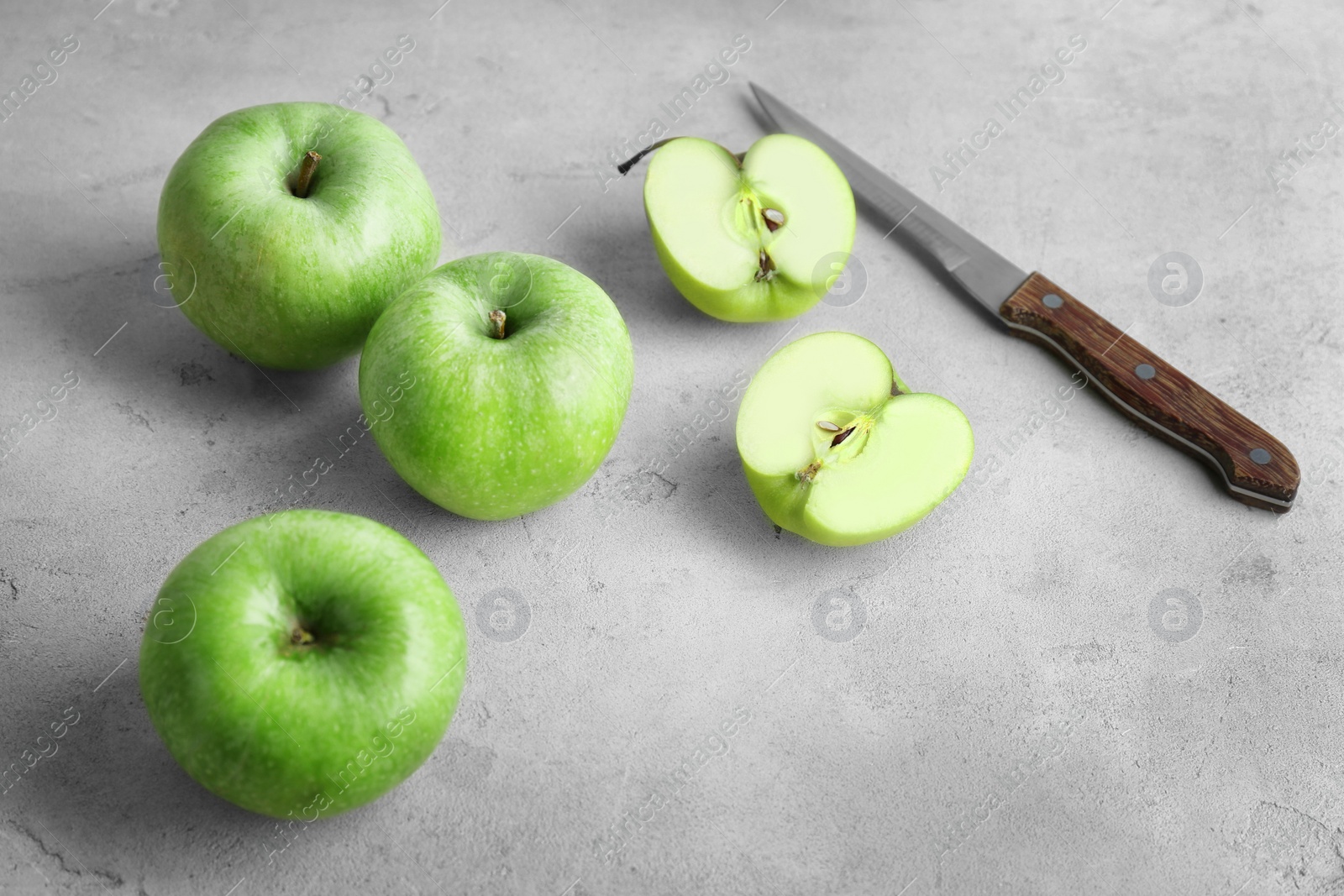 Fresh green apples and knife on table Photo of Fresh green apples and knife on table