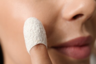 Woman using silkworm cocoon in skin care routine, closeup Photo of Woman using silkworm cocoon in skin care routine, closeup