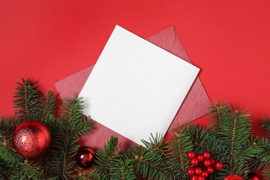 Flat lay composition with blank greeting card and Christmas decor on red background, space for text Photo of Flat lay composition with blank greeting card and Christmas decor on red background, space for text