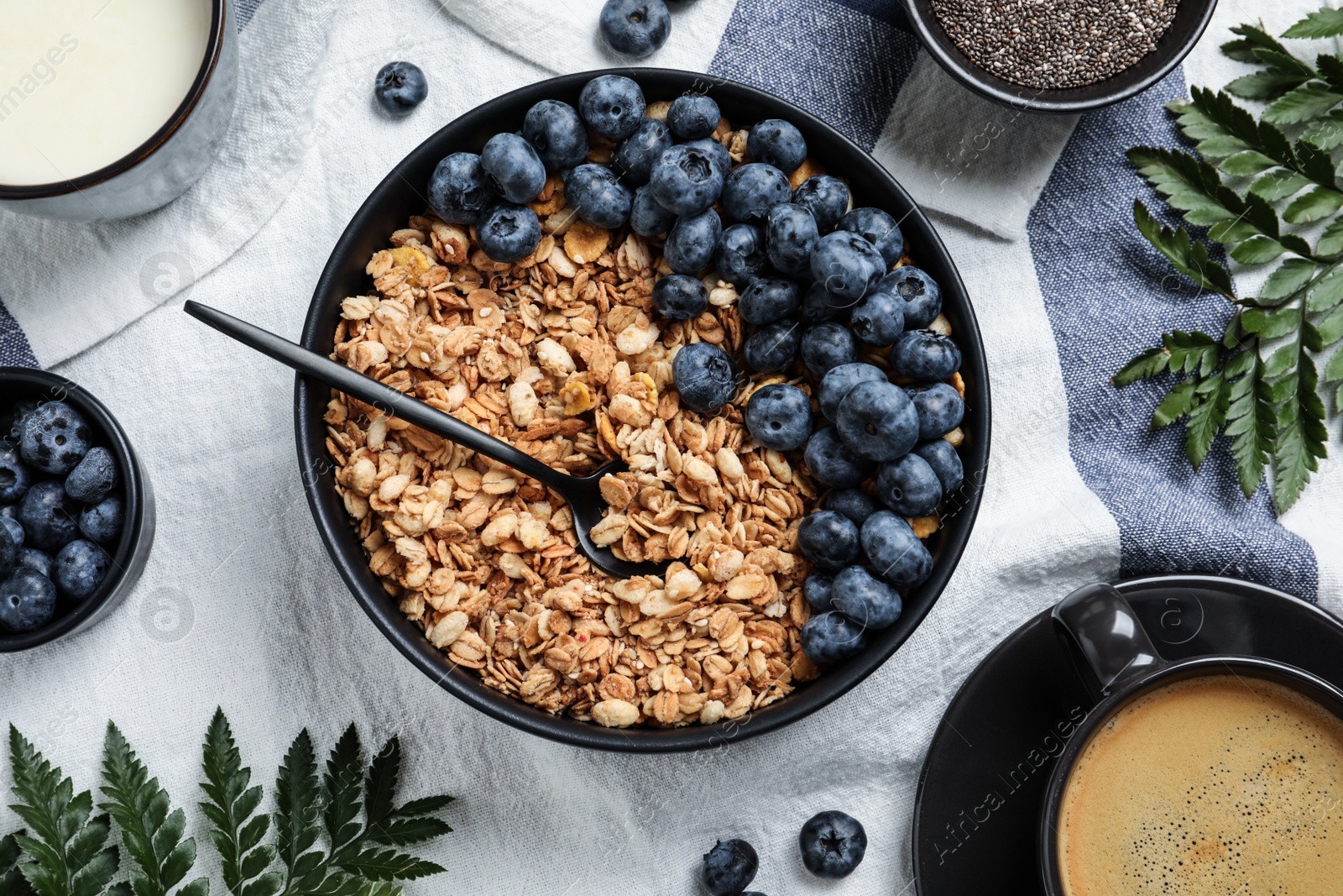 Bowl of oat with blueberry served on table, flat lay Photo of Bowl of oat with blueberry served on table, flat lay