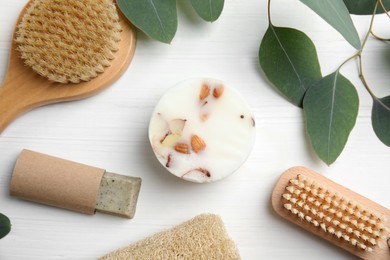 Eco friendly personal care products and leaves on white wooden table, flat lay Photo of Eco friendly personal care products and leaves on white wooden table, flat lay