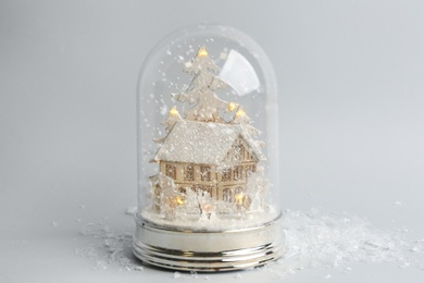 Beautiful snow globe on light grey background Photo of Beautiful snow globe on light grey background