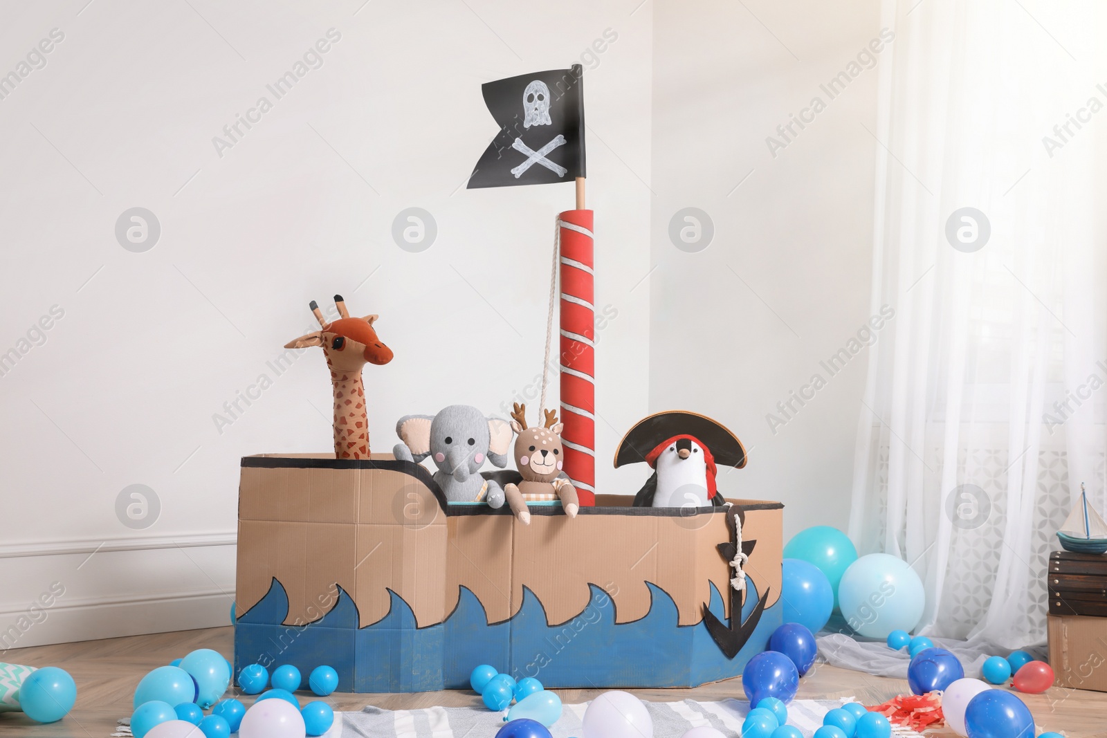 Child's room interior with pirate cardboard ship and toys Photo of Child's room interior with pirate cardboard ship and toys
