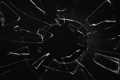 Broken glass with cracks on black background Image of Broken glass with cracks on black background